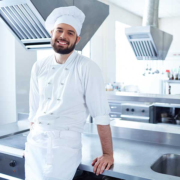 A chef posing near the kitchen table